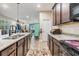 An open kitchen featuring granite countertops, dark wood cabinetry, and stainless appliances at 450 Harbor Springs Dr, Palm Harbor, FL 34683