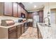 Kitchen features dark wood cabinetry, granite counters, and stainless appliances at 450 Harbor Springs Dr, Palm Harbor, FL 34683