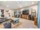 Open-concept living area with wood-look flooring, a large TV, and comfortable seating at 450 Harbor Springs Dr, Palm Harbor, FL 34683