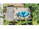 Aerial view of a private pool with surrounding patio and lush landscaping at 450 Harbor Springs Dr, Palm Harbor, FL 34683