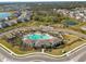 Aerial view of a community pool, clubhouse, playground, and surrounding neighborhood at 4727 Lindever Ln, Palmetto, FL 34221