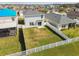 Backyard view of home with a white fence enclosing a well-maintained lawn at 4727 Lindever Ln, Palmetto, FL 34221