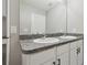 The bathroom features double sinks, gray counters, white cabinets, and a large mirror at 4727 Lindever Ln, Palmetto, FL 34221