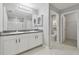 Bathroom featuring a double sink vanity with white cabinets, a shower, and a toilet room at 4727 Lindever Ln, Palmetto, FL 34221