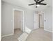 This bedroom has carpet, a ceiling fan, gray walls, a closet, and a bathroom at 4727 Lindever Ln, Palmetto, FL 34221