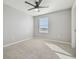 This bedroom has gray walls, tan carpet, a window, and a ceiling fan at 4727 Lindever Ln, Palmetto, FL 34221