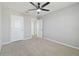 Bedroom with gray walls, neutral carpet, and white doors at 4727 Lindever Ln, Palmetto, FL 34221