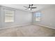 This bedroom offers carpet, gray walls, recessed lighting, and two windows at 4727 Lindever Ln, Palmetto, FL 34221