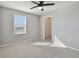 This bedroom features gray walls, tan carpet, a window, a ceiling fan, and a closet at 4727 Lindever Ln, Palmetto, FL 34221
