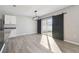 Bright dining area with laminate floors, sliding glass doors, and modern lighting fixtures at 4727 Lindever Ln, Palmetto, FL 34221