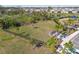 Overhead view of a fenced dog park within a residential area with palm trees and lush green surroundings at 4727 Lindever Ln, Palmetto, FL 34221