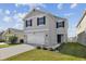 Two-story home with a wide driveway, complemented by green grass and trimmed landscaping at 4727 Lindever Ln, Palmetto, FL 34221