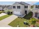 Two-story home featuring a two-car garage, tidy landscaping, and a welcoming entryway at 4727 Lindever Ln, Palmetto, FL 34221