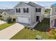 Two-story home featuring a two-car garage, tidy landscaping, and a welcoming entryway at 4727 Lindever Ln, Palmetto, FL 34221