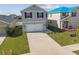 Front exterior of home featuring a long driveway and well-maintained landscaping at 4727 Lindever Ln, Palmetto, FL 34221