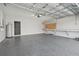 View of a garage with epoxy flooring, shelving, and an installed water heater at 4727 Lindever Ln, Palmetto, FL 34221