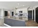 Open kitchen featuring a kitchen island with granite countertops, stainless steel appliances, and white cabinets at 4727 Lindever Ln, Palmetto, FL 34221