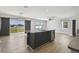 Open kitchen with a modern island, stainless appliances, and sliding glass doors to outdoor space at 4727 Lindever Ln, Palmetto, FL 34221