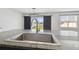 Granite countertop on a kitchen island with a stainless steel sink and a view of the backyard at 4727 Lindever Ln, Palmetto, FL 34221