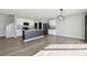 Spacious living room open to the kitchen featuring a large island, stainless steel appliances, and laminate floors at 4727 Lindever Ln, Palmetto, FL 34221