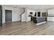 Open living room with kitchen view, featuring modern appliances and wood-style floors at 4727 Lindever Ln, Palmetto, FL 34221