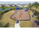 Overhead view of a neighborhood playground set near a pond with lush landscaping and benches at 4727 Lindever Ln, Palmetto, FL 34221