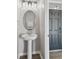 Stylish powder room with pedestal sink, updated lighting and black trim at 4727 Lindever Ln, Palmetto, FL 34221