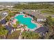 Aerial view of a large swimming pool, palm trees, and shaded lounge areas at 4727 Lindever Ln, Palmetto, FL 34221