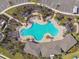 Community swimming pool showcasing lounge chairs, pergolas, landscaping, and a building at 4727 Lindever Ln, Palmetto, FL 34221