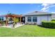 A spacious backyard features a pergola over a patio area, perfect for outdoor entertaining and relaxation at 6113 Plover Meadow St, Lithia, FL 33547