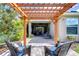 Charming pergola in a well-manicured backyard with lush landscaping and comfortable seating at 6113 Plover Meadow St, Lithia, FL 33547