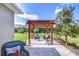 Landscaped backyard with a charming pergola and paver patio, ideal for outdoor entertaining at 6113 Plover Meadow St, Lithia, FL 33547