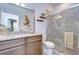 Well-lit bathroom with tile floors, a large mirror, and a glass enclosed shower at 6113 Plover Meadow St, Lithia, FL 33547