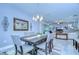Formal dining room view with a decorative wall mirror, modern chandelier, and neutral toned furnishings at 6113 Plover Meadow St, Lithia, FL 33547