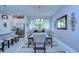Formal dining room featuring a decorative chandelier and view of the kitchen and stainless steel appliances at 6113 Plover Meadow St, Lithia, FL 33547