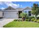 Charming single-story home featuring a brick-paved driveway and meticulously landscaped front yard at 6113 Plover Meadow St, Lithia, FL 33547