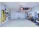 Large garage with epoxy floors and overhead storage racks, perfect for organization at 6113 Plover Meadow St, Lithia, FL 33547