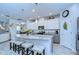 The kitchen features an island with seating, stainless steel appliances, and a view into the living area at 6113 Plover Meadow St, Lithia, FL 33547