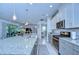 The open kitchen features an island with seating, stainless steel appliances, and seamless flow to the living areas at 6113 Plover Meadow St, Lithia, FL 33547
