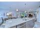 Island in kitchen with stainless steel appliances and an open view of the dining and living areas at 6113 Plover Meadow St, Lithia, FL 33547