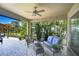 Relaxing screened-in lanai featuring comfortable seating and lush tropical landscaping at 6113 Plover Meadow St, Lithia, FL 33547