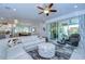 Open concept living room with a large white sectional sofa, and view of dining room and the covered patio at 6113 Plover Meadow St, Lithia, FL 33547