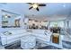 Open concept living room with tile floors, a ceiling fan, recessed lights and a large white sectional sofa at 6113 Plover Meadow St, Lithia, FL 33547