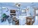 Bright living room with tile floors, a ceiling fan, recessed lights and a large white sectional sofa at 6113 Plover Meadow St, Lithia, FL 33547