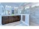 Bright main bathroom with double sink vanity, a glass enclosed shower and large mirrors at 6113 Plover Meadow St, Lithia, FL 33547