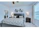 Cozy main bedroom featuring two windows, bedside tables with lamps, and carpet floors at 6113 Plover Meadow St, Lithia, FL 33547