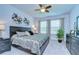 Spacious main bedroom featuring three large windows, a ceiling fan, and neutral-colored walls and carpet at 6113 Plover Meadow St, Lithia, FL 33547