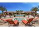 Luxurious community pool area featuring lounge chairs, palm trees, and a nearby spa under a clear blue sky at 6113 Plover Meadow St, Lithia, FL 33547
