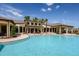 Expansive community pool with clear blue water, palm trees, and a covered lounge area for relaxing poolside at 6113 Plover Meadow St, Lithia, FL 33547