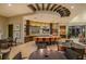 Social area with a large bar, multiple TVs, and dining tables offering entertainment and casual dining options at 6113 Plover Meadow St, Lithia, FL 33547